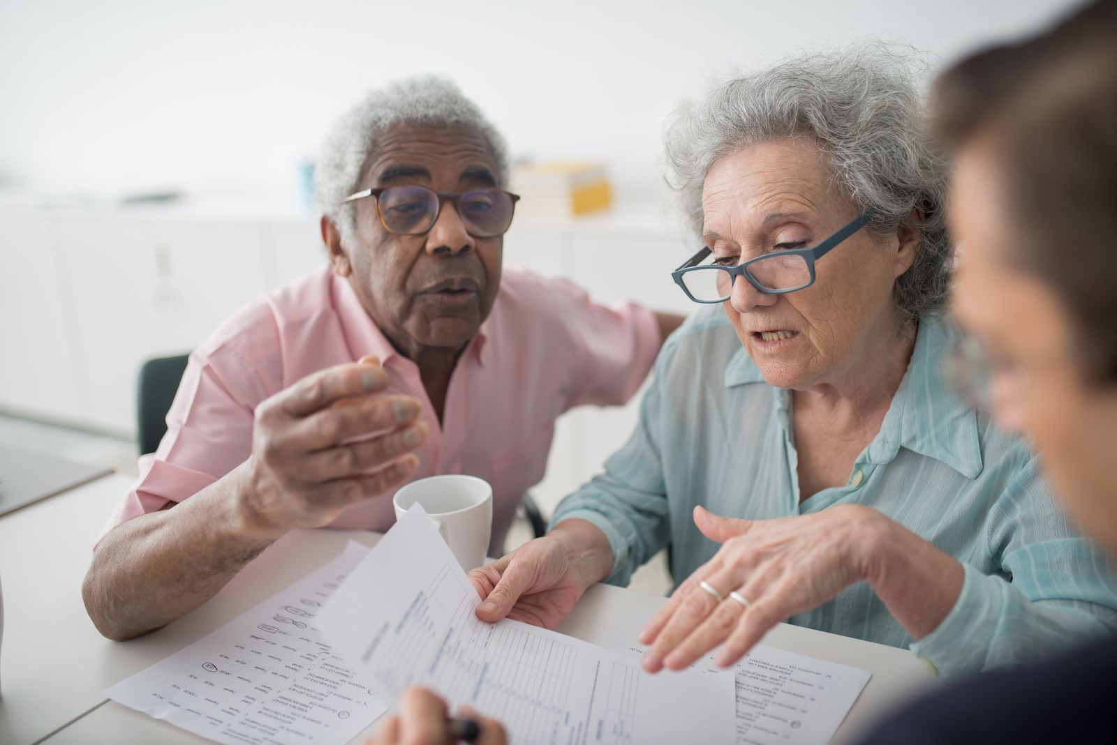 Stock photograph of a couple discussing financial planning with an adviser