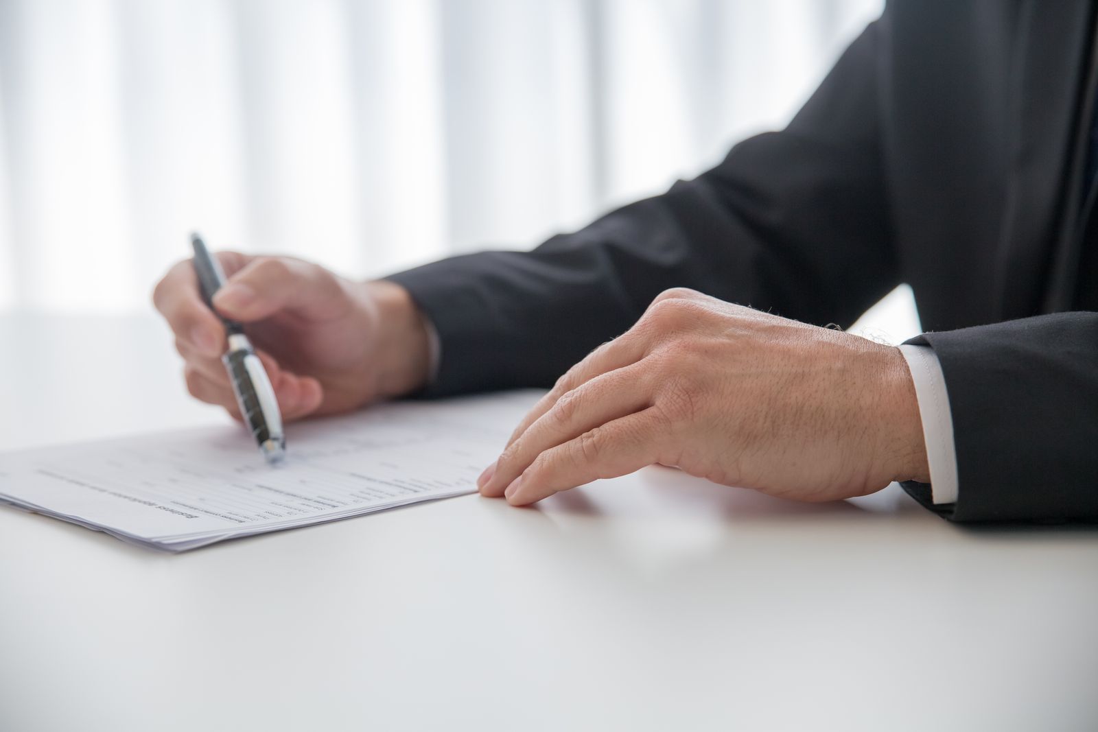 Stock photograph of a professional completing registration paperwork