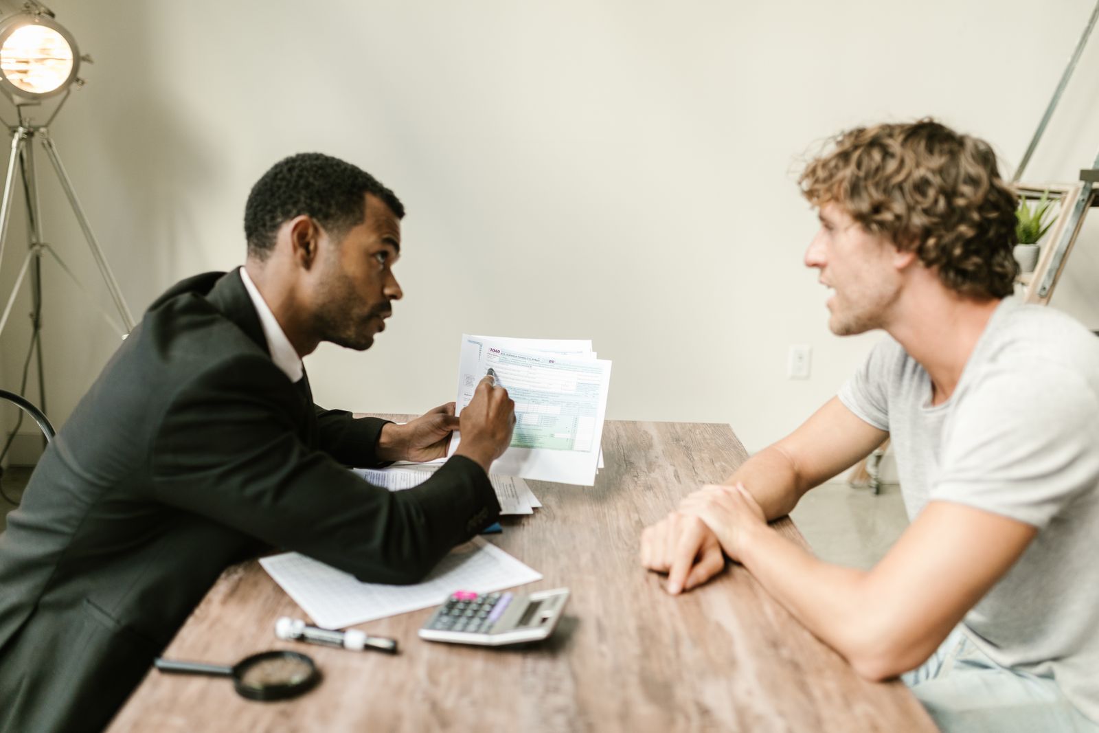An adviser reviewing financial paperwork with a client